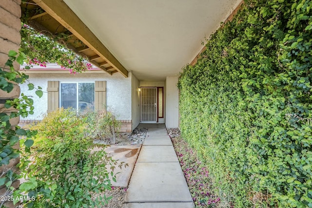 entrance to property featuring stucco siding