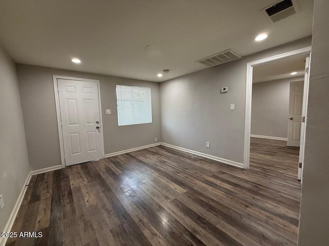 empty room featuring dark hardwood / wood-style flooring