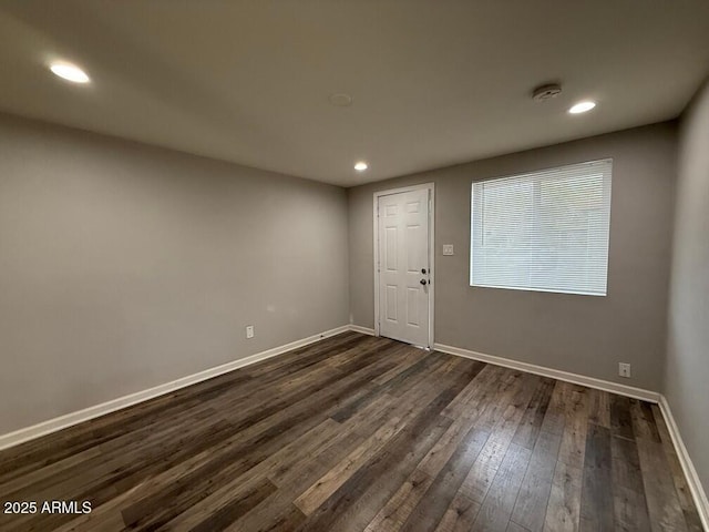 spare room featuring dark wood-type flooring