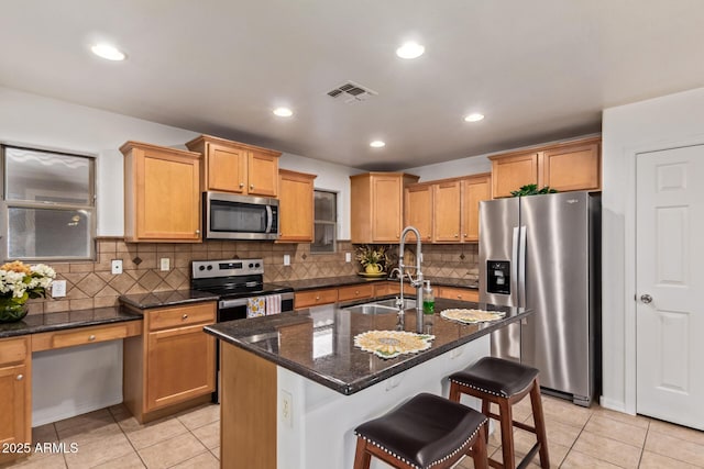 kitchen featuring a sink, stainless steel appliances, light tile patterned flooring, and visible vents