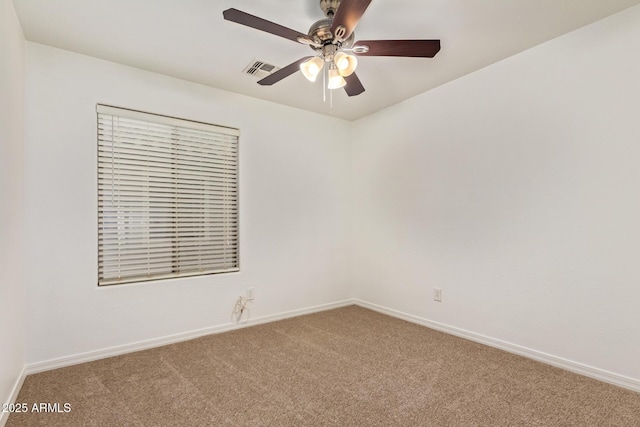 empty room featuring baseboards, carpet flooring, visible vents, and a ceiling fan