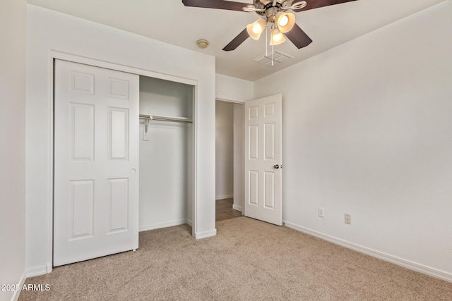 unfurnished bedroom with baseboards, visible vents, a closet, and carpet flooring