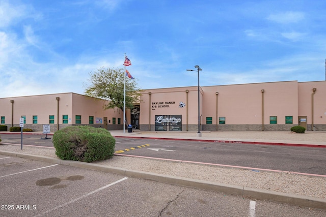 view of building exterior with uncovered parking