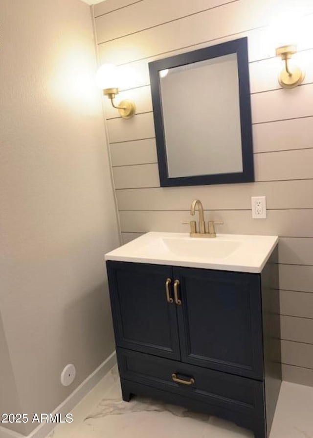 bathroom with vanity and wooden walls