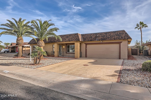 view of front of home featuring a garage and central AC unit