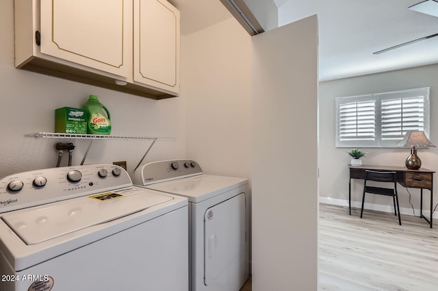 laundry room with washer and dryer, cabinets, and light hardwood / wood-style flooring