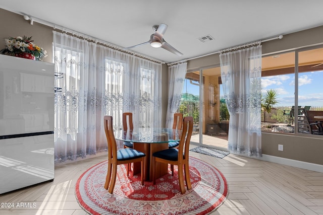 dining area featuring ceiling fan and light parquet flooring