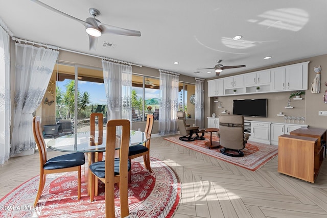 dining space featuring ceiling fan and light parquet flooring