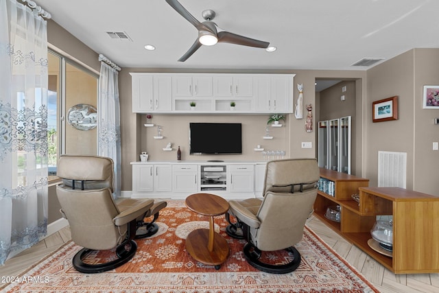 living room with ceiling fan and light hardwood / wood-style floors