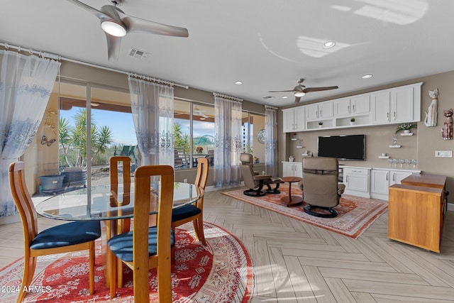 dining room featuring ceiling fan and light parquet floors