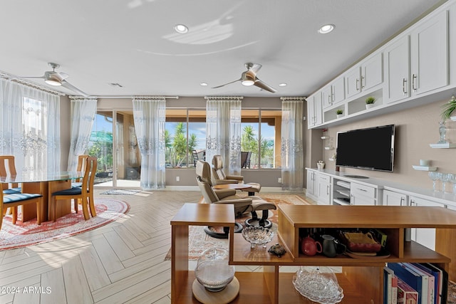 living room with ceiling fan and light parquet flooring