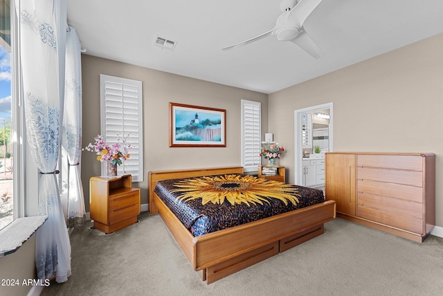 carpeted bedroom featuring ceiling fan and connected bathroom