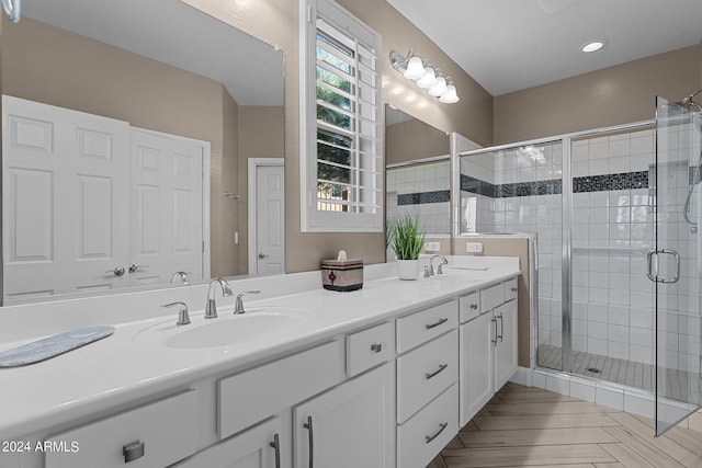 bathroom featuring vanity and an enclosed shower