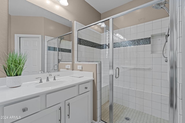 bathroom featuring walk in shower and vanity