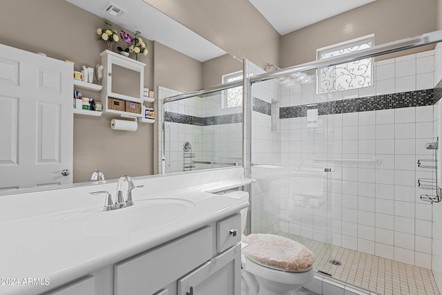 bathroom featuring toilet, an enclosed shower, and vanity