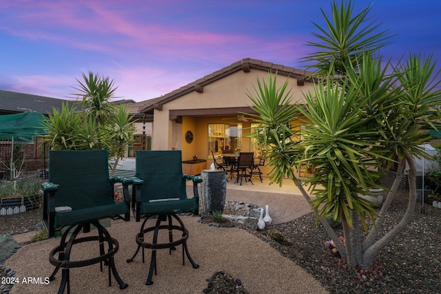 view of patio terrace at dusk