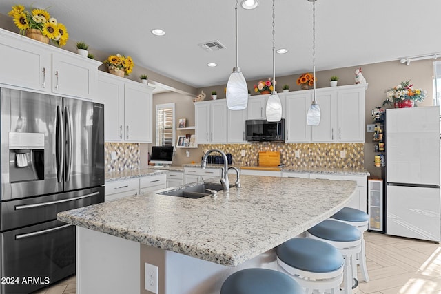 kitchen with a kitchen island with sink, sink, stainless steel appliances, and white cabinets