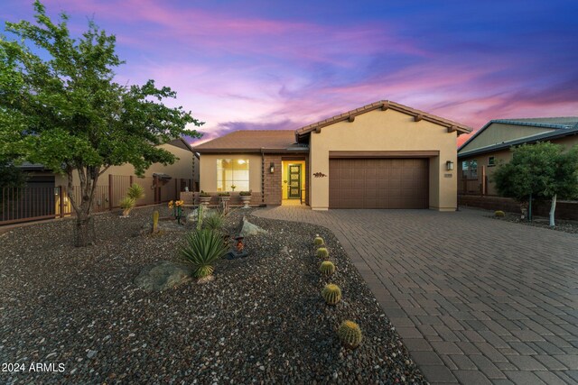 back house at dusk featuring a patio area