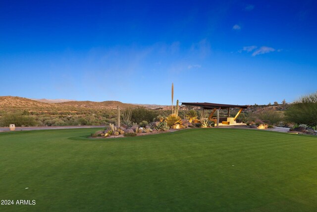 view of community featuring a mountain view and a yard