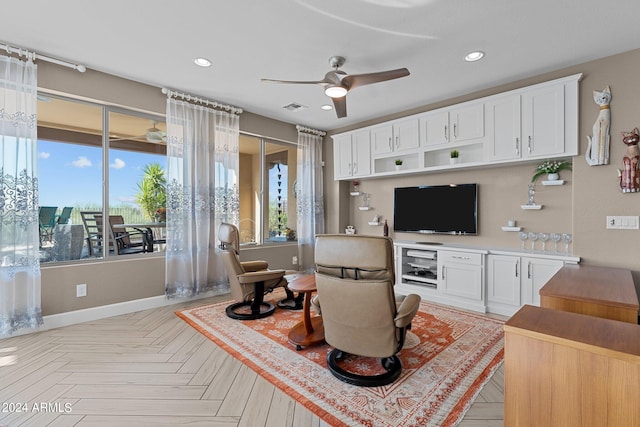 living room with ceiling fan and light parquet flooring