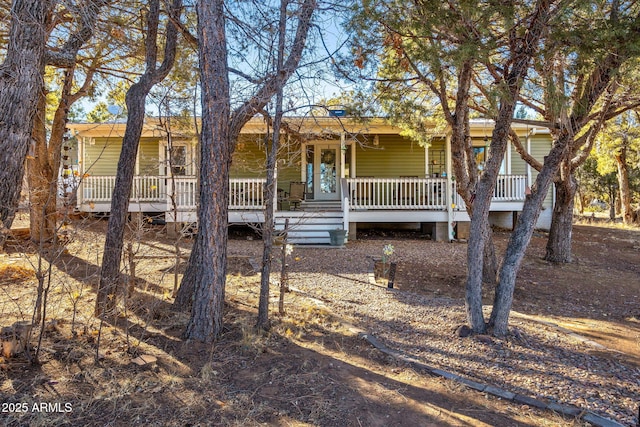 rear view of house featuring a porch