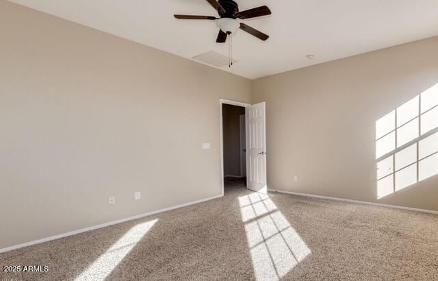 15105 W Glenrosa Ave, Goodyear, AZ 85395 - empty room featuring carpet flooring, a ceiling fan, and baseboards