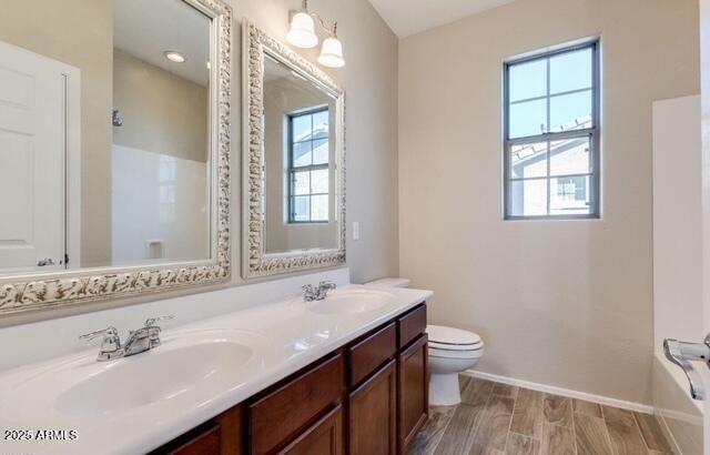 15105 W Glenrosa Ave, Goodyear, AZ 85395 - full bath with healthy amount of natural light, double vanity, toilet, and a tub to relax in