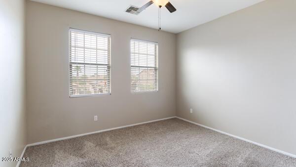 15105 W Glenrosa Ave, Goodyear, AZ 85395 - spare room with a ceiling fan, healthy amount of natural light, and carpet