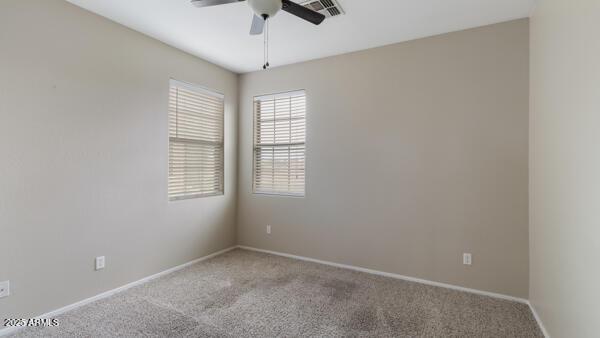 15105 W Glenrosa Ave, Goodyear, AZ 85395 - spare room featuring carpet flooring, ceiling fan, and baseboards