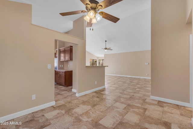 15232 S 36th Pl, Phoenix, AZ 85044 - spare room featuring a ceiling fan, baseboards, light stone finish flooring, and high vaulted ceiling
