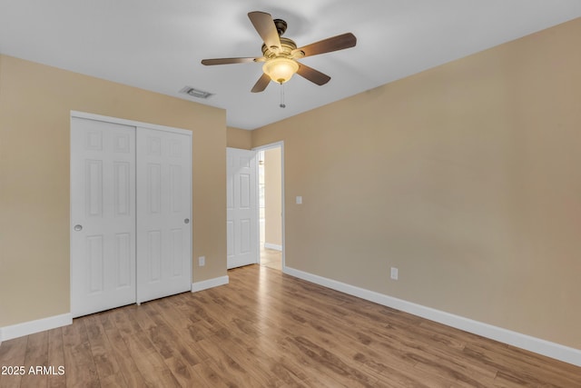 15232 S 36th Pl, Phoenix, AZ 85044 - unfurnished bedroom with baseboards, wood finished floors, a closet, and a ceiling fan