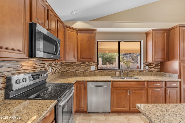 15232 S 36th Pl, Phoenix, AZ 85044 - kitchen with appliances with stainless steel finishes, a sink, lofted ceiling, backsplash, and light stone countertops
