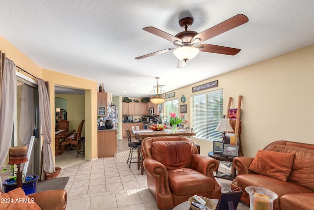 tiled living room with a textured ceiling and ceiling fan