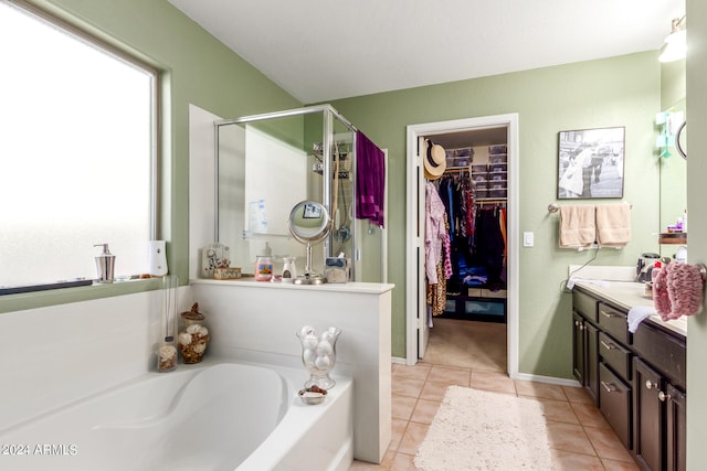 bathroom featuring vanity, plus walk in shower, and tile patterned floors