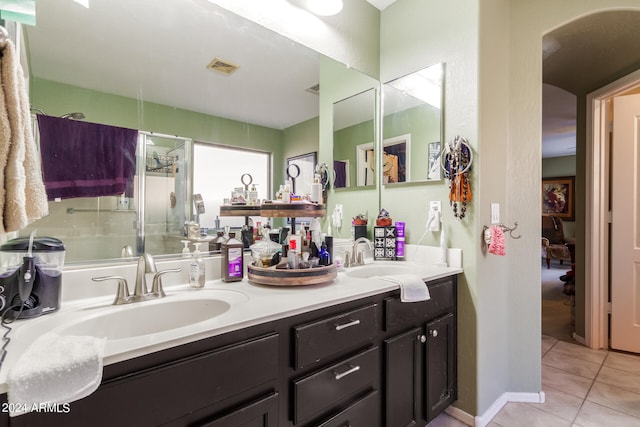 bathroom with vanity, an enclosed shower, and tile patterned floors