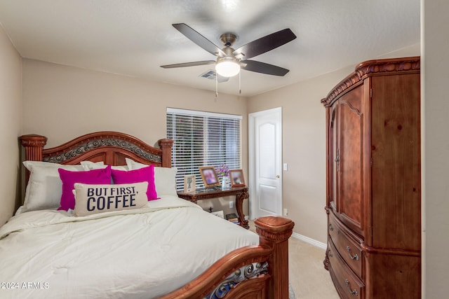 bedroom with light carpet, a textured ceiling, and ceiling fan