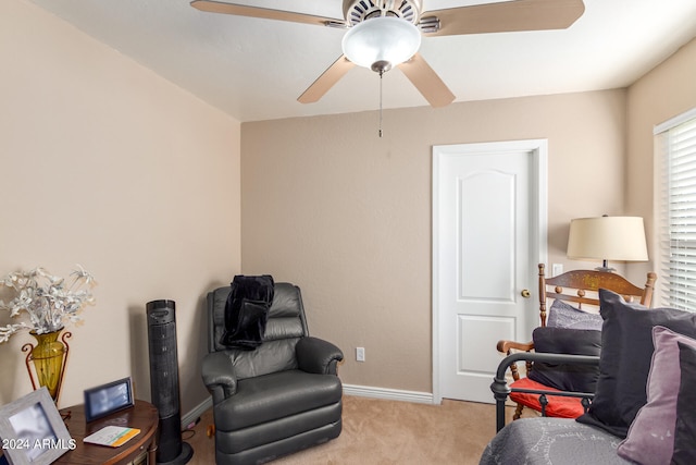 living area featuring ceiling fan and light colored carpet