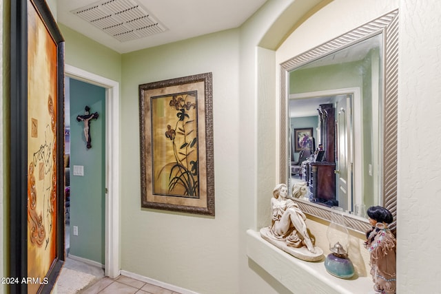 hall featuring light tile patterned flooring