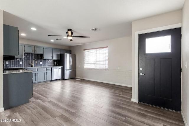 2914 W Marlette Ave, Phoenix, AZ 85017 - kitchen with ceiling fan, appliances with stainless steel finishes, baseboards, wood finished floors, and visible vents