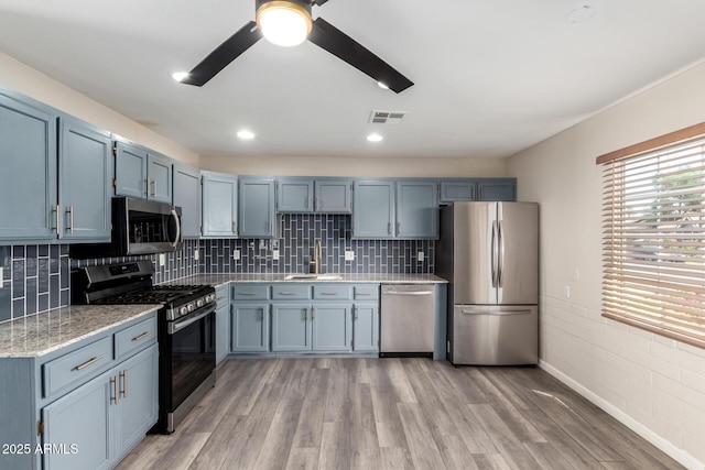 2914 W Marlette Ave, Phoenix, AZ 85017 - kitchen with appliances with stainless steel finishes, a sink, light wood-style flooring, a ceiling fan, and visible vents