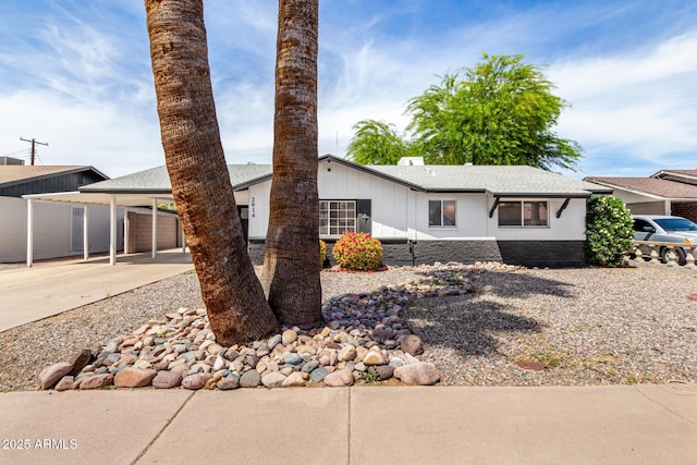 2914 W Marlette Ave, Phoenix, AZ 85017 - view of front of property with roof with shingles, a carport, board and batten siding, and driveway
