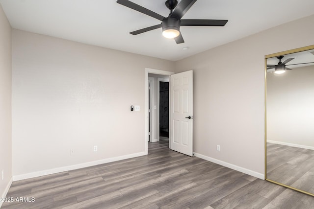2914 W Marlette Ave, Phoenix, AZ 85017 - unfurnished bedroom featuring baseboards, a ceiling fan, wood finished floors, and a closet