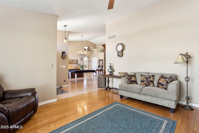 4401 E Barwick Dr, Cave Creek, AZ 85331 - living area featuring a chandelier, vaulted ceiling, ceiling fan, wood finished floors, and baseboards