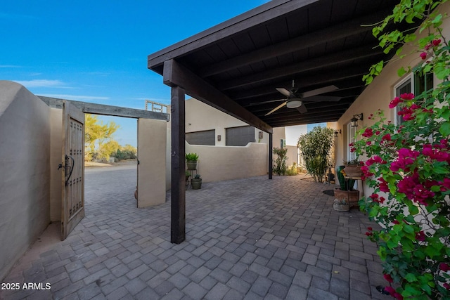 view of patio / terrace featuring a ceiling fan and fence