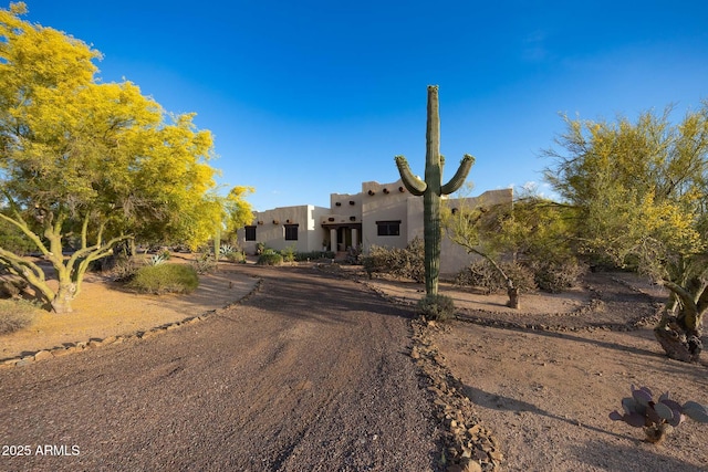 pueblo revival-style home with stucco siding