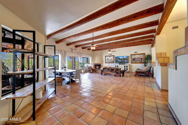living room with light tile patterned floors, ceiling fan, beamed ceiling, and baseboards