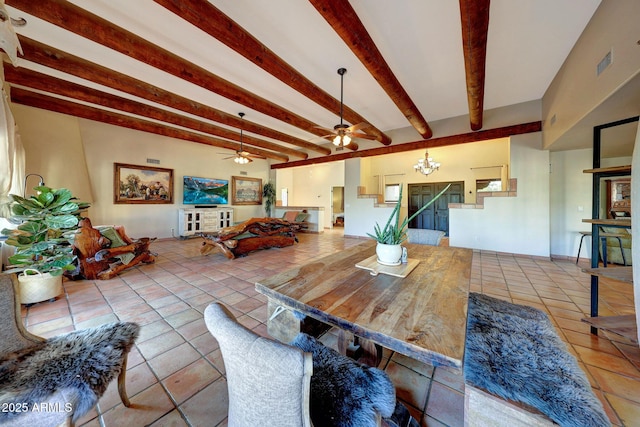 dining room with beam ceiling, ceiling fan, tile patterned flooring, and a chandelier