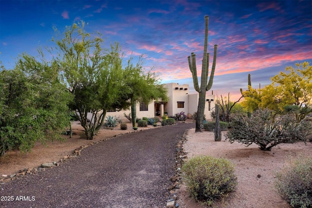 pueblo-style home featuring stucco siding