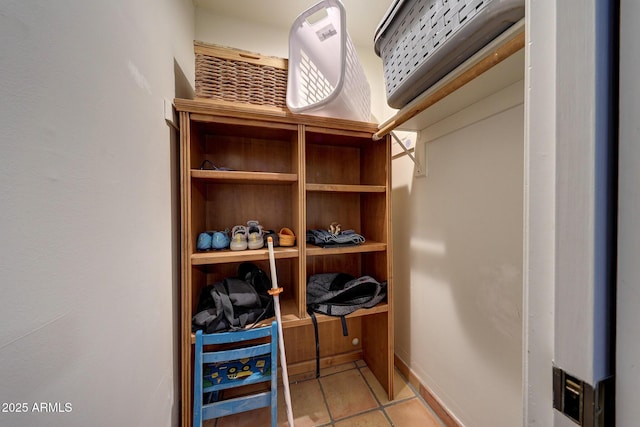 walk in closet with tile patterned floors