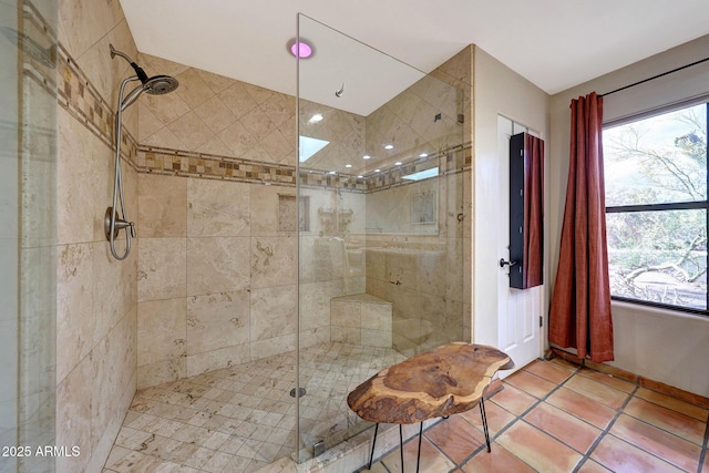 bathroom with a stall shower, healthy amount of natural light, and tile patterned floors